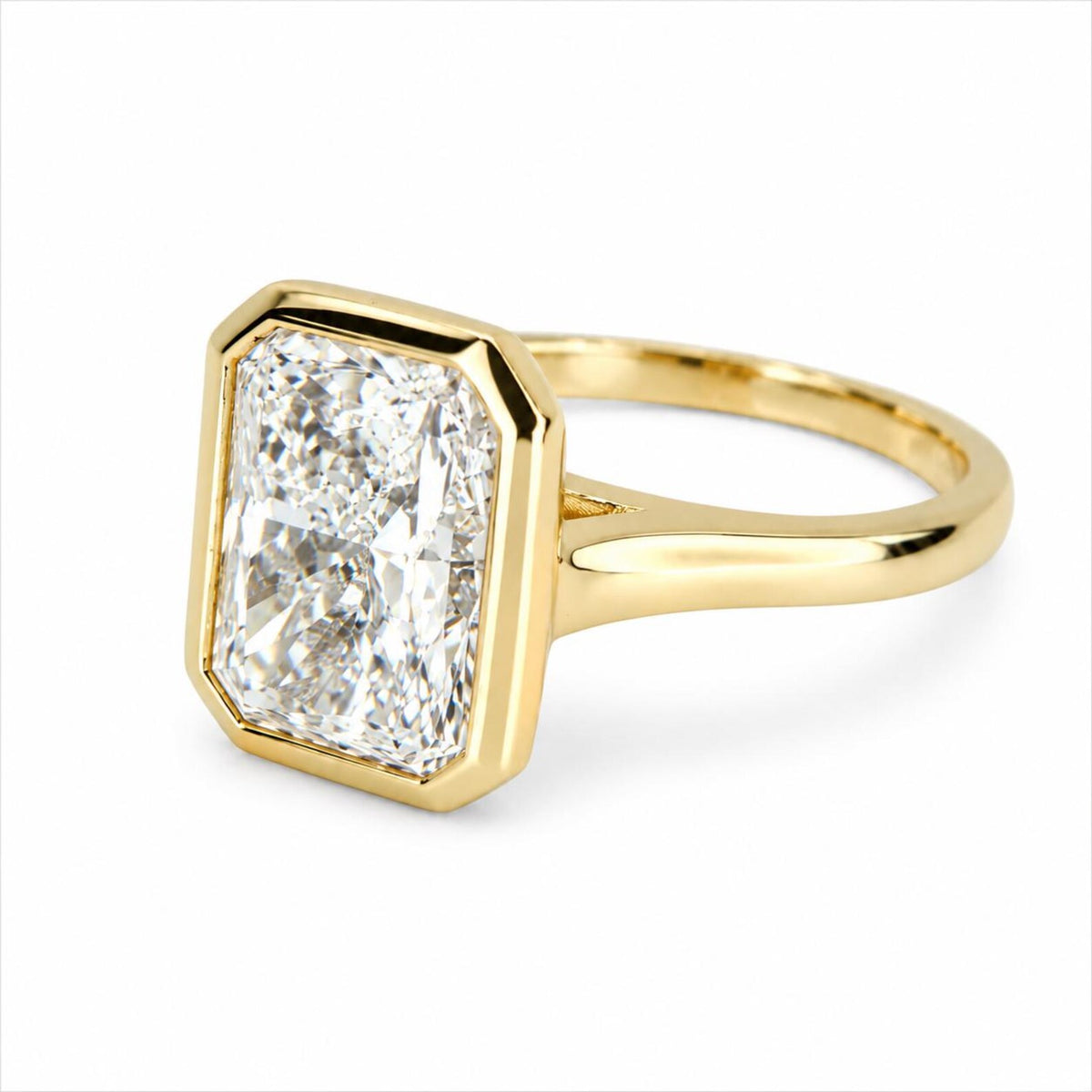 Three-quarter perspective of a 4 CT radiant cut lab diamond solitaire ring with smooth yellow gold bezel.
