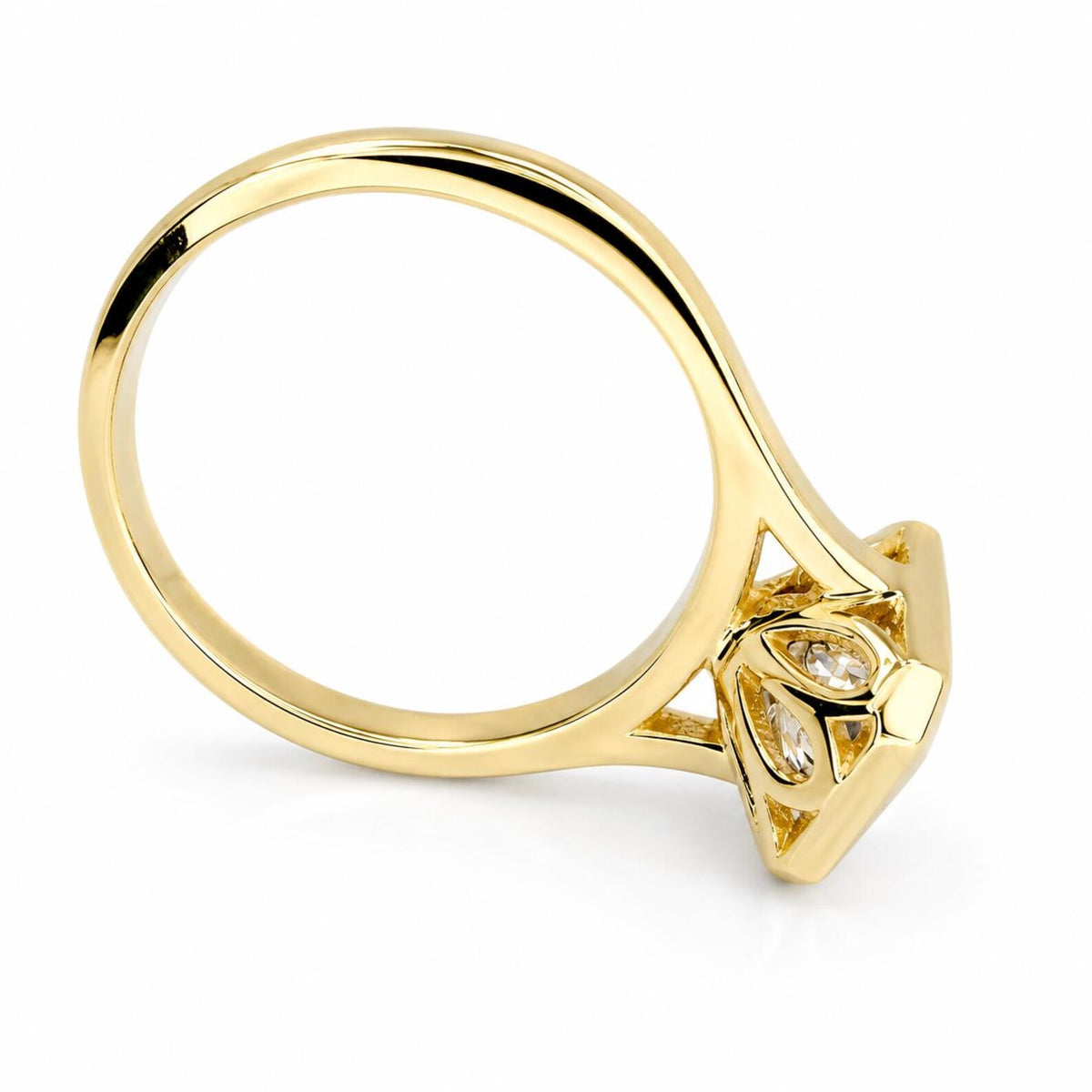 Tilted profile shot showing the polished yellow gold band and carved undergallery of a 4 CT radiant lab diamond ring.