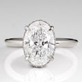 Top view of a 3 CT oval cut lab grown diamond engagement ring with claw prongs in white gold.