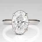 Top view of a 3 CT oval cut lab grown diamond engagement ring with claw prongs in white gold.