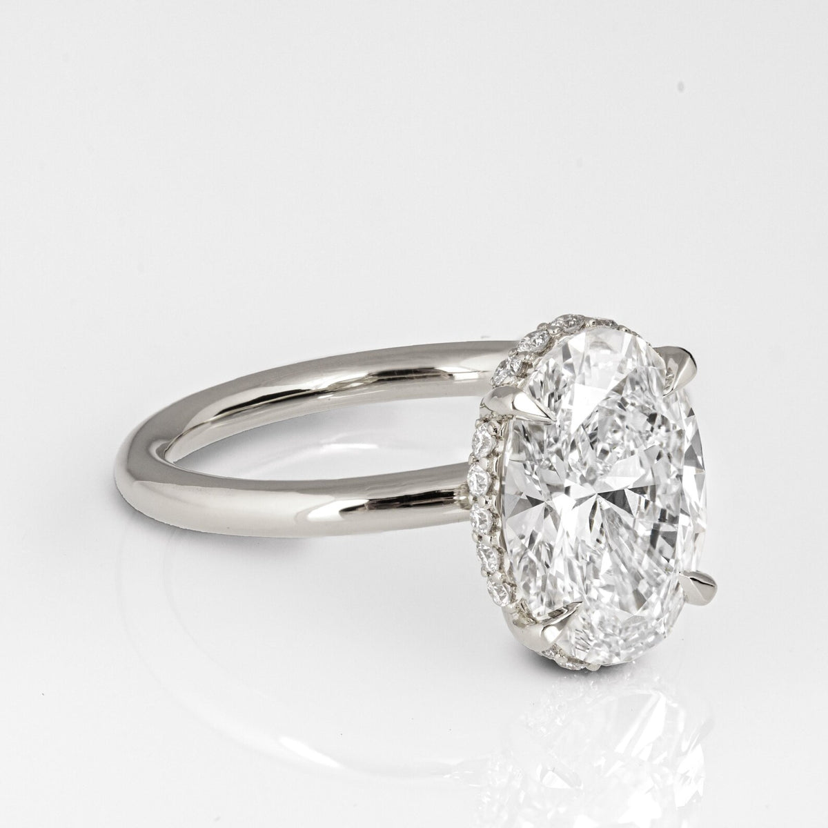 Perspective view of an elongated 3 CT oval cut lab grown diamond ring on a plain white gold band.