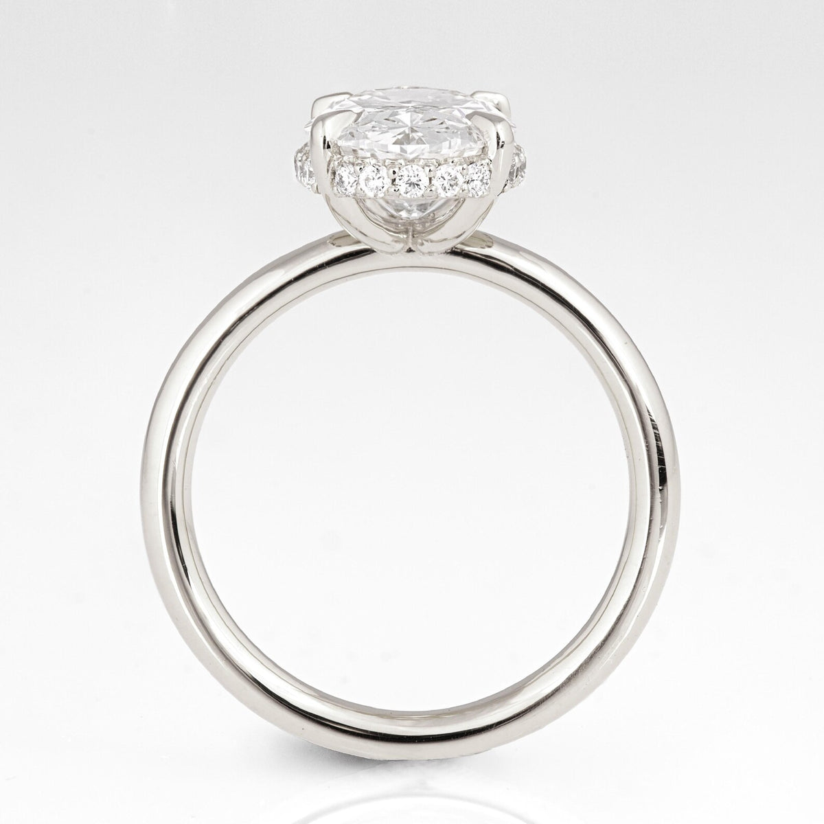 Profile view looking through the band showcasing the hidden halo setting on a 3 CT oval lab diamond ring.