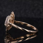 Side profile view of a 3 CT oval cut lab grown diamond ring with carved filigree halo setting in yellow gold.