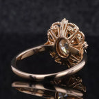 Undergallery view showing the sculpted sunburst filigree lattice under the basket of a 3 CT oval lab diamond ring.