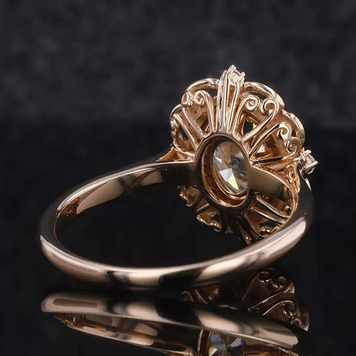 Undergallery view showing the sculpted sunburst filigree lattice under the basket of a 3 CT oval lab diamond ring.