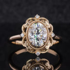 Direct top view of a 3 CT oval cut lab grown diamond surrounded by an ornate milgrain filigree halo on a polished gold band.