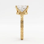 Side profile view showing intricate scrollwork engraving on a 14K yellow gold band with a 3 CT oval diamond.