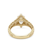 Undergallery view showing openwork filigree scrollwork on a 4 CT marquise lab diamond gold ring.