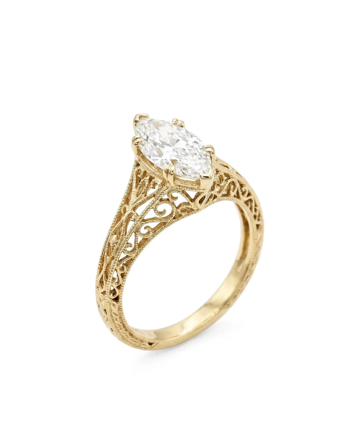 Three-quarter perspective view of a 4 CT marquise lab diamond engagement ring with broad filigree shoulders.