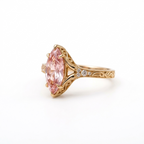 Side profile angle of a 3 CT pink marquise lab grown diamond ring with filigree scrollwork in rose gold.