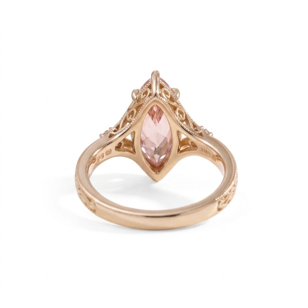 Undergallery basket view of a pink marquise diamond engagement ring showing hallmark stamps in rose gold.