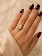 On-hand view of a 4 CT emerald cut lab diamond engagement ring in hand-carved vintage bezel setting.
