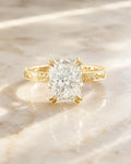Front view of a 3 CT elongated cushion cut lab grown diamond ring resting on a marble surface.