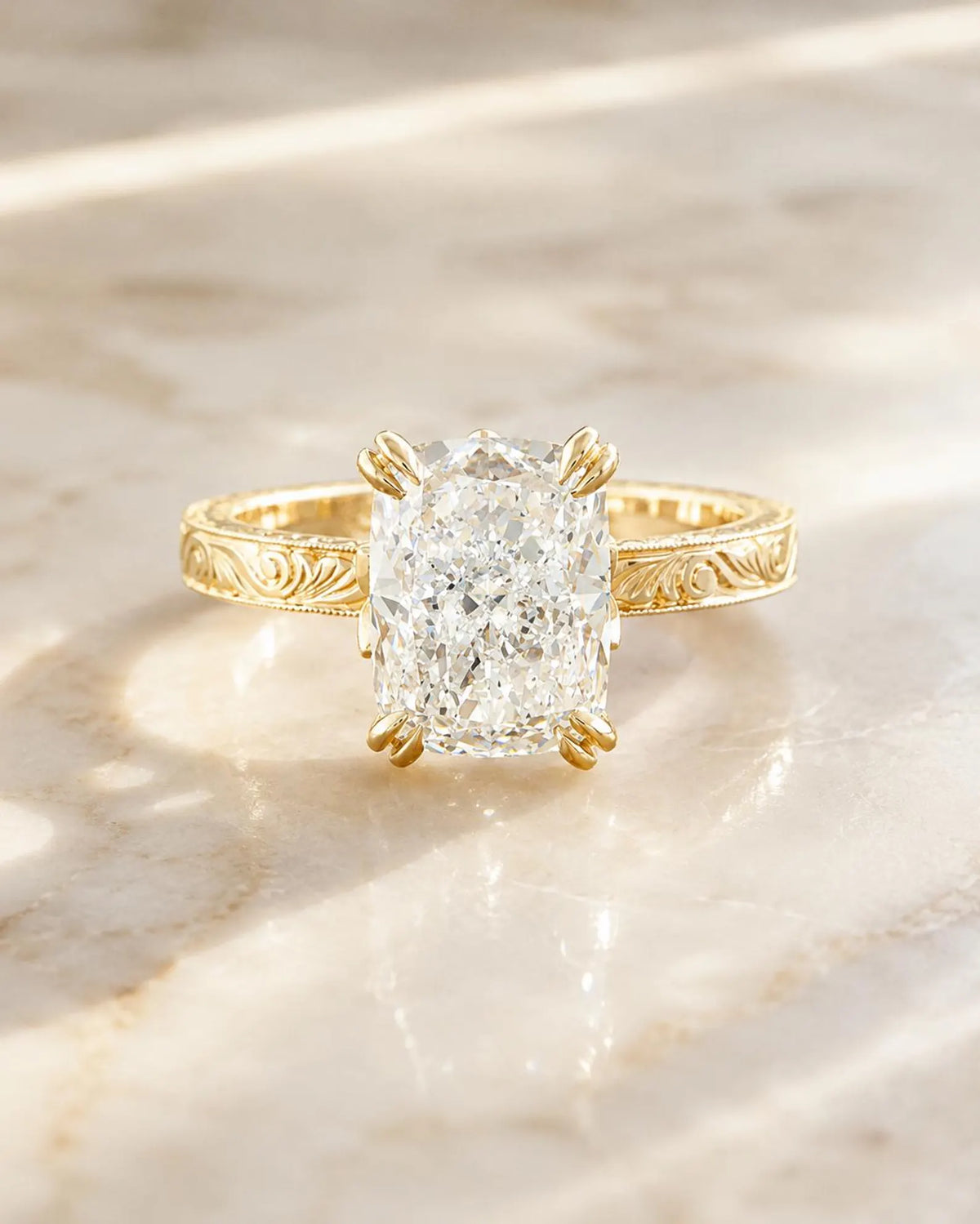 Front view of a 3 CT elongated cushion cut lab grown diamond ring resting on a marble surface.