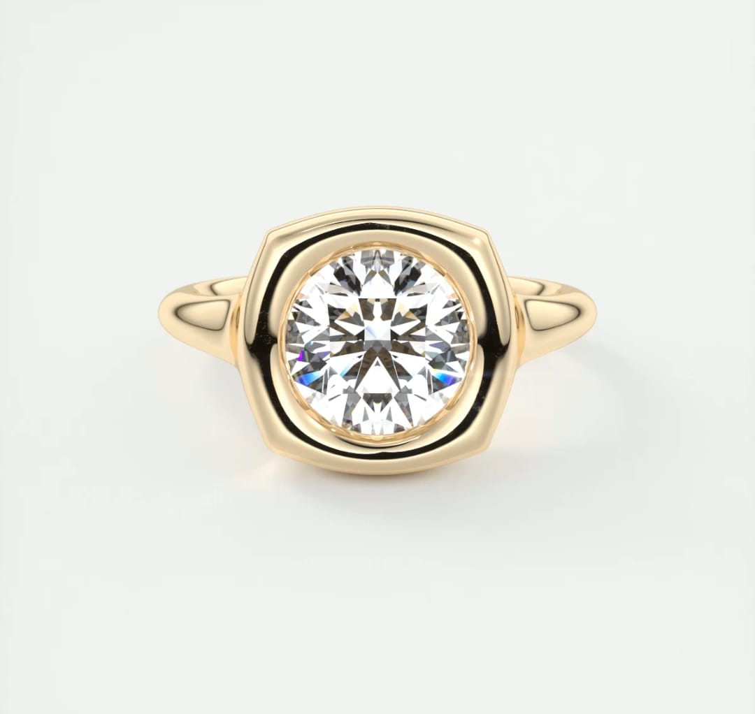 Top-down view of a 3 CT round lab grown diamond set in a yellow gold cushion bezel frame.