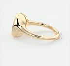 Side view of a yellow gold bezel solitaire ring showcasing the low profile and smooth shank.