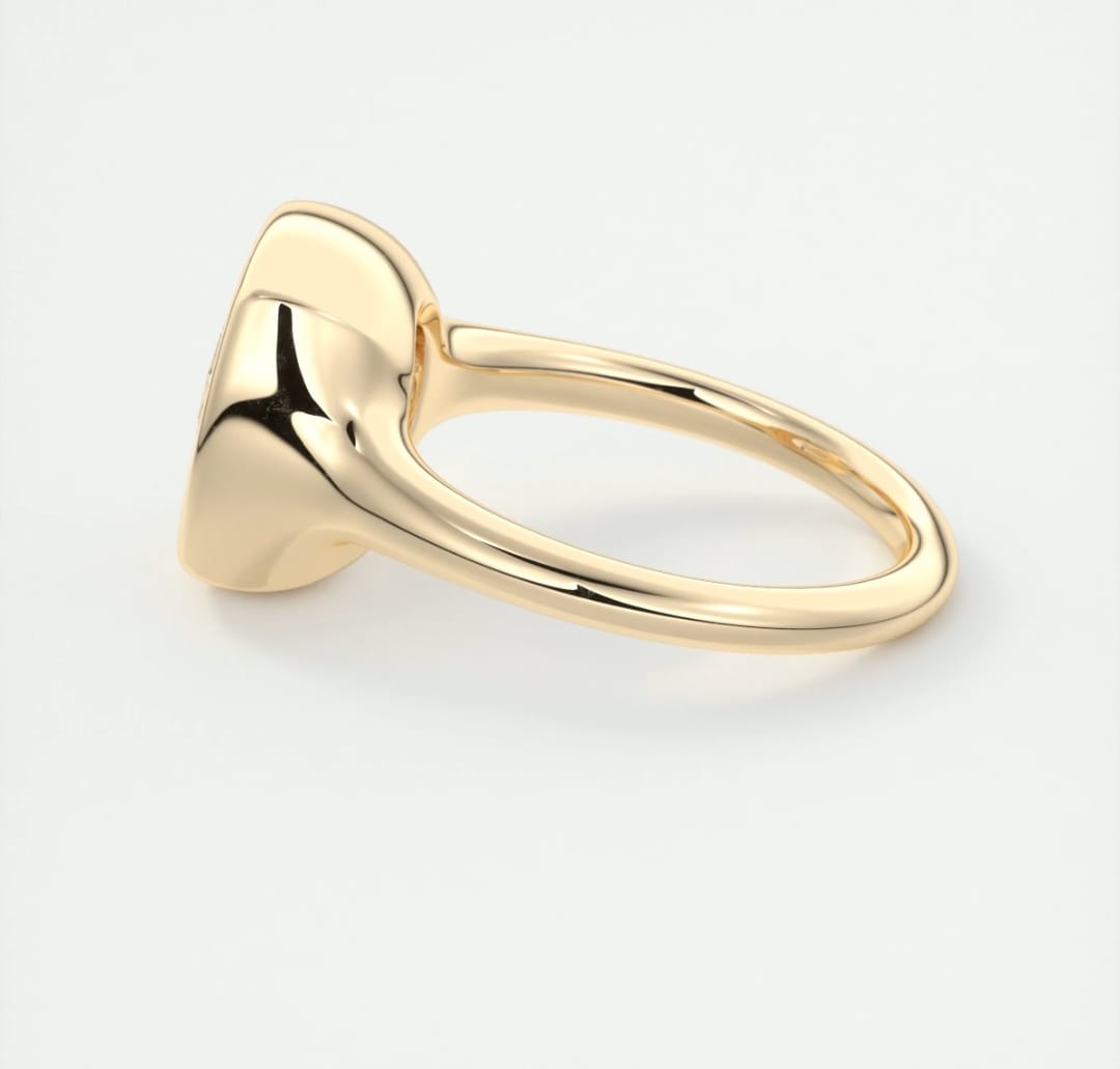 Side view of a yellow gold bezel solitaire ring showcasing the low profile and smooth shank.