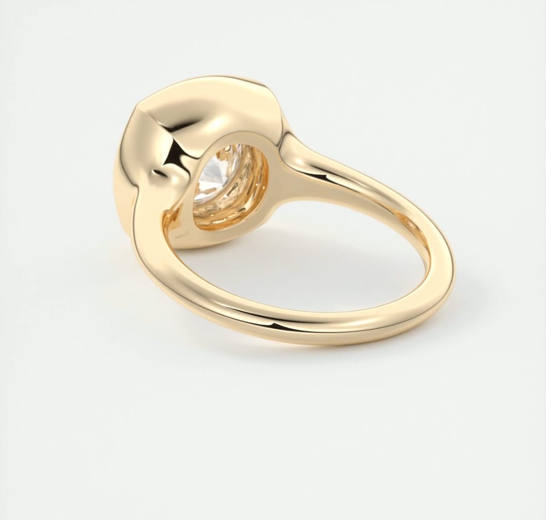 Bottom angle view highlighting the open under-gallery setting of the yellow gold bezel diamond ring.