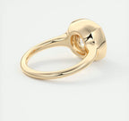 Side perspective of the polished 14K yellow gold band tapering into a full bezel ring head.