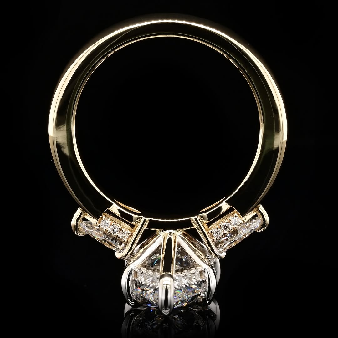 A yellow gold ring with a large clear center diamond and smaller diamonds set in a silver-colored pavé band, shown against a solid black background.