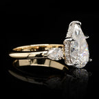 High-detail side angle highlighting the brilliant facets of the 4 CT pear-cut center lab diamond and smooth yellow gold shank