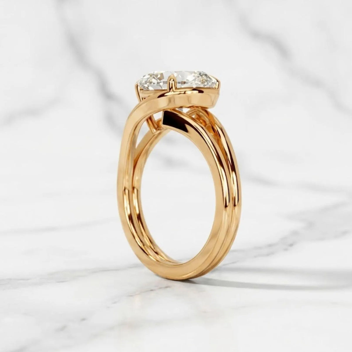 Side profile of a 14K yellow gold ring featuring a sweeping double-strand band and East-West pear diamond.
