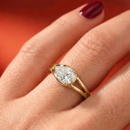On-finger view of a 2 CT pear cut lab grown diamond East-West engagement ring in yellow gold.
