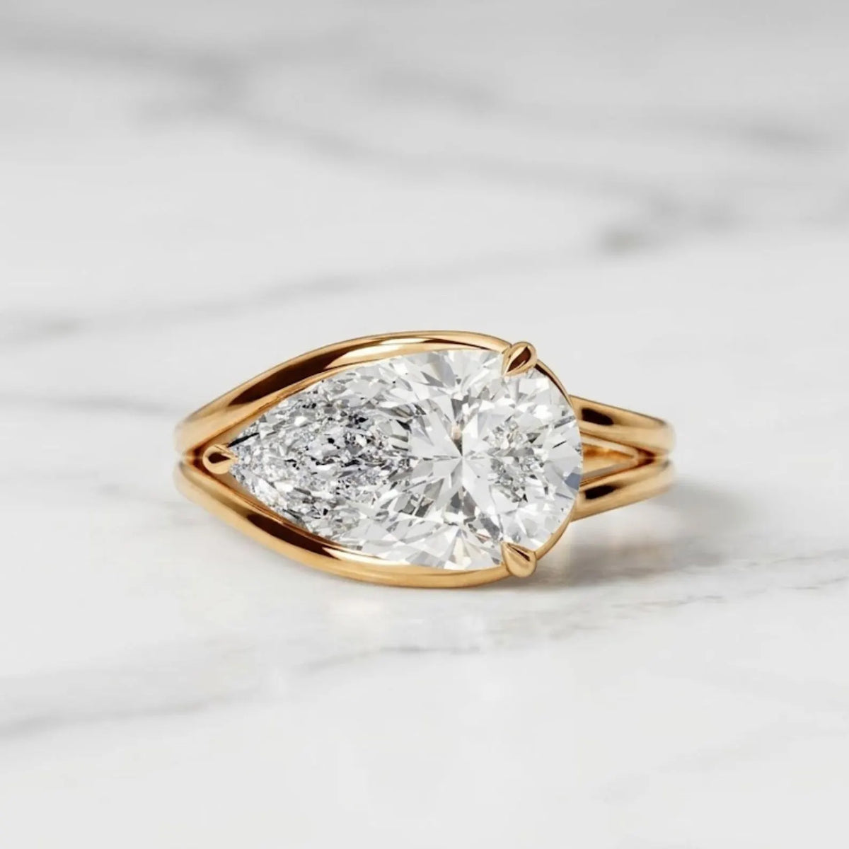 Direct top view displaying the brilliant horizontal pear cut diamond set in a gold bezel setting.