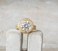 Front view of a 4 CT round lab grown diamond ring with brushed yellow gold halo bezel and flush diamond accents.