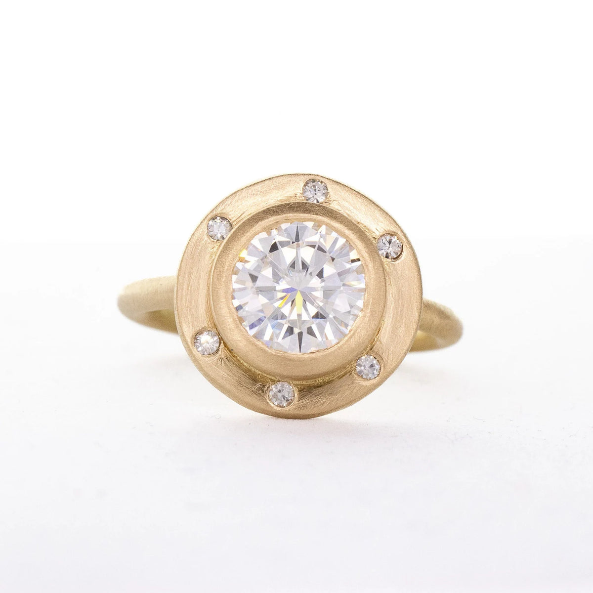 Direct top view of a 4 CT round lab grown diamond set in a wide satin-brushed gold halo with six flush diamond accents.