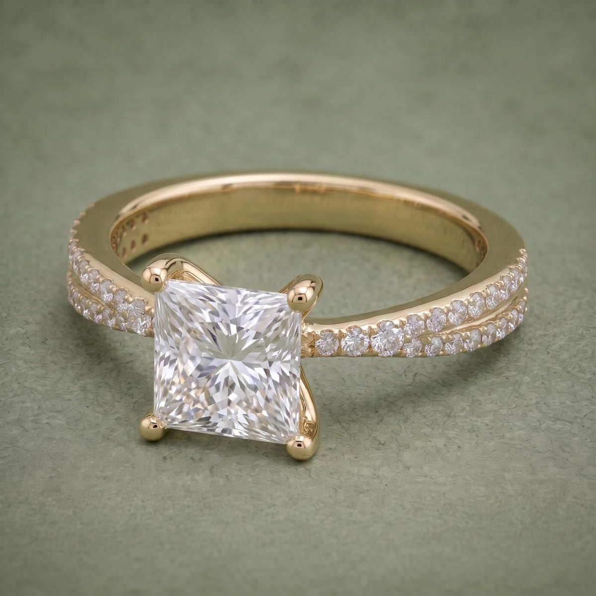 Angled front view of a 2 CT princess cut lab grown diamond ring with double pavé band in 14K yellow gold.