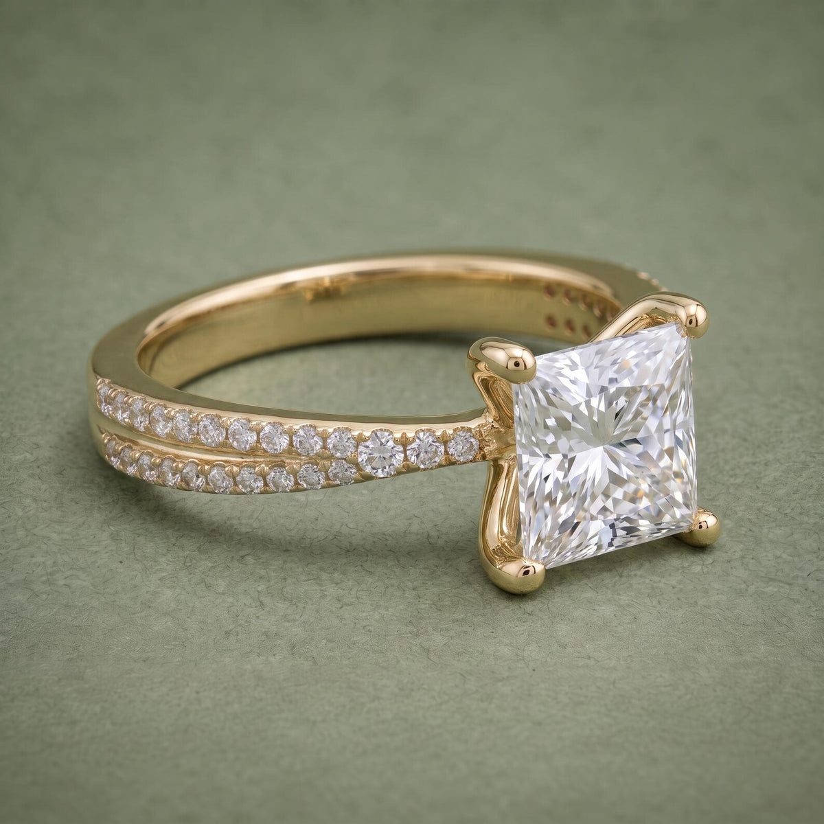 Close-up angled view highlighting the square 2 CT princess cut diamond and sparkling side pavé diamonds.
