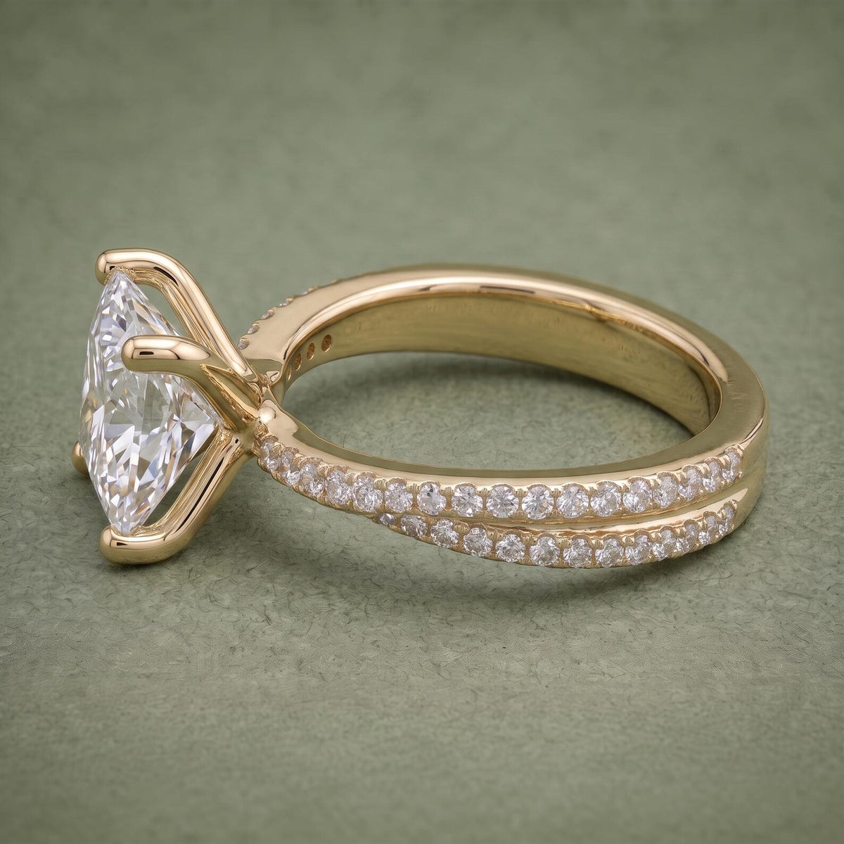 Detailed profile view of the double-row pavé band running up the shank of a yellow gold engagement ring.