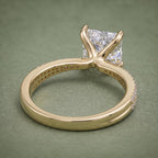 Undergallery and inside band view of a 14K yellow gold princess cut diamond ring with drilled light ports.