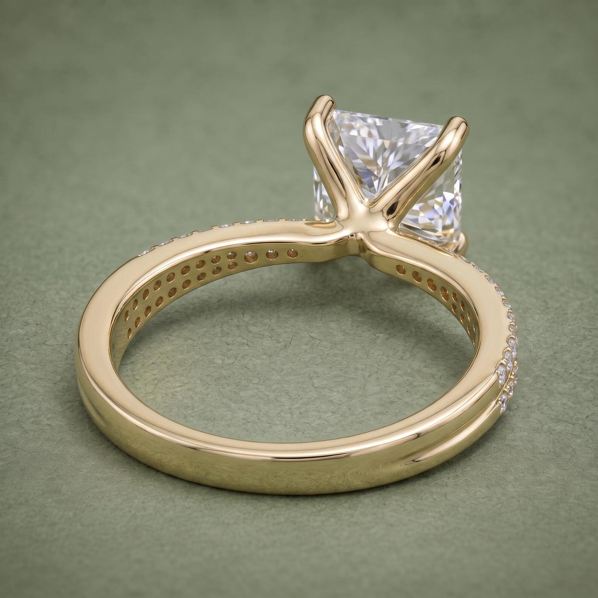 Undergallery and inside band view of a 14K yellow gold princess cut diamond ring with drilled light ports.