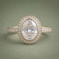 Top-down view of a 4 CT oval lab grown diamond engagement ring with a bezel halo setting in 14K yellow gold.