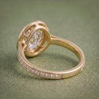 Angled bottom profile of a 14K yellow gold engagement ring highlighting the inner band and structural halo base.