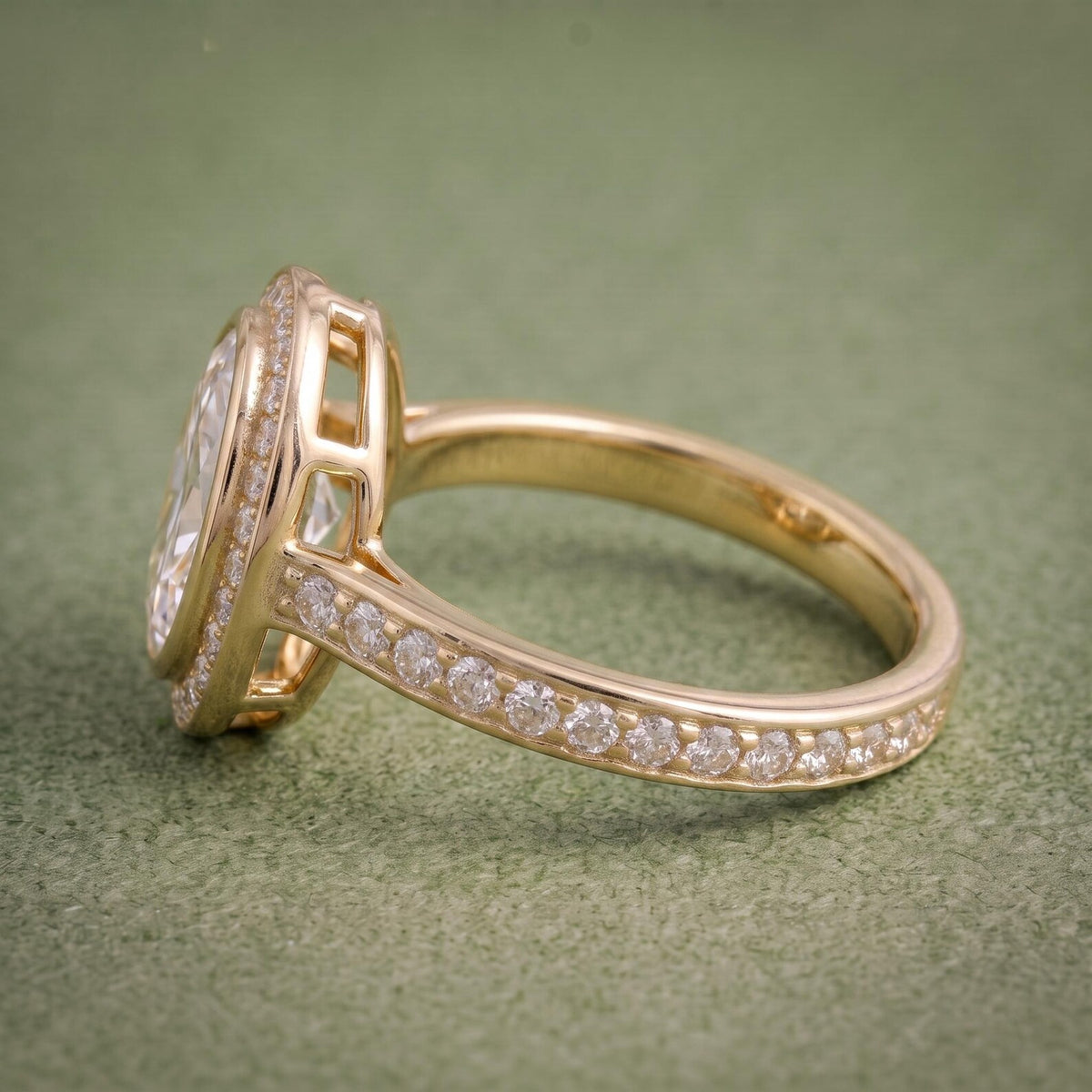 Side angle view displaying the setting height, open gallery windows, and pavé shank of the yellow gold ring.