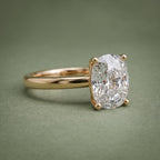 Angled front perspective of a 3 CT elongated cushion cut lab grown diamond solitaire ring in 18K yellow gold.