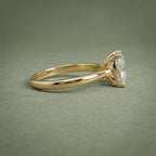 Side profile view of a yellow gold engagement ring featuring a 4-prong basket setting and smooth band.