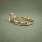 Close profile view of the raised 4-prong setting cradling a 3 carat cushion cut lab grown diamond.