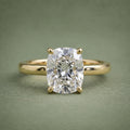 Direct top view of a 3 CT elongated cushion cut lab grown diamond set on a plain 18K yellow gold band.