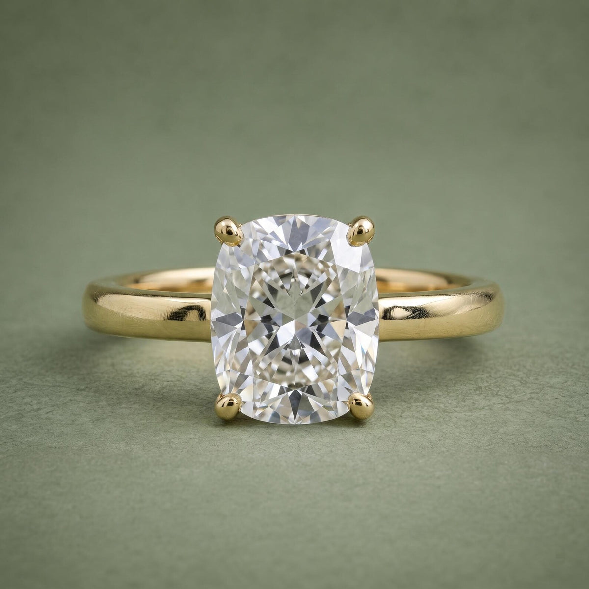 Direct top view of a 3 CT elongated cushion cut lab grown diamond set on a plain 18K yellow gold band.