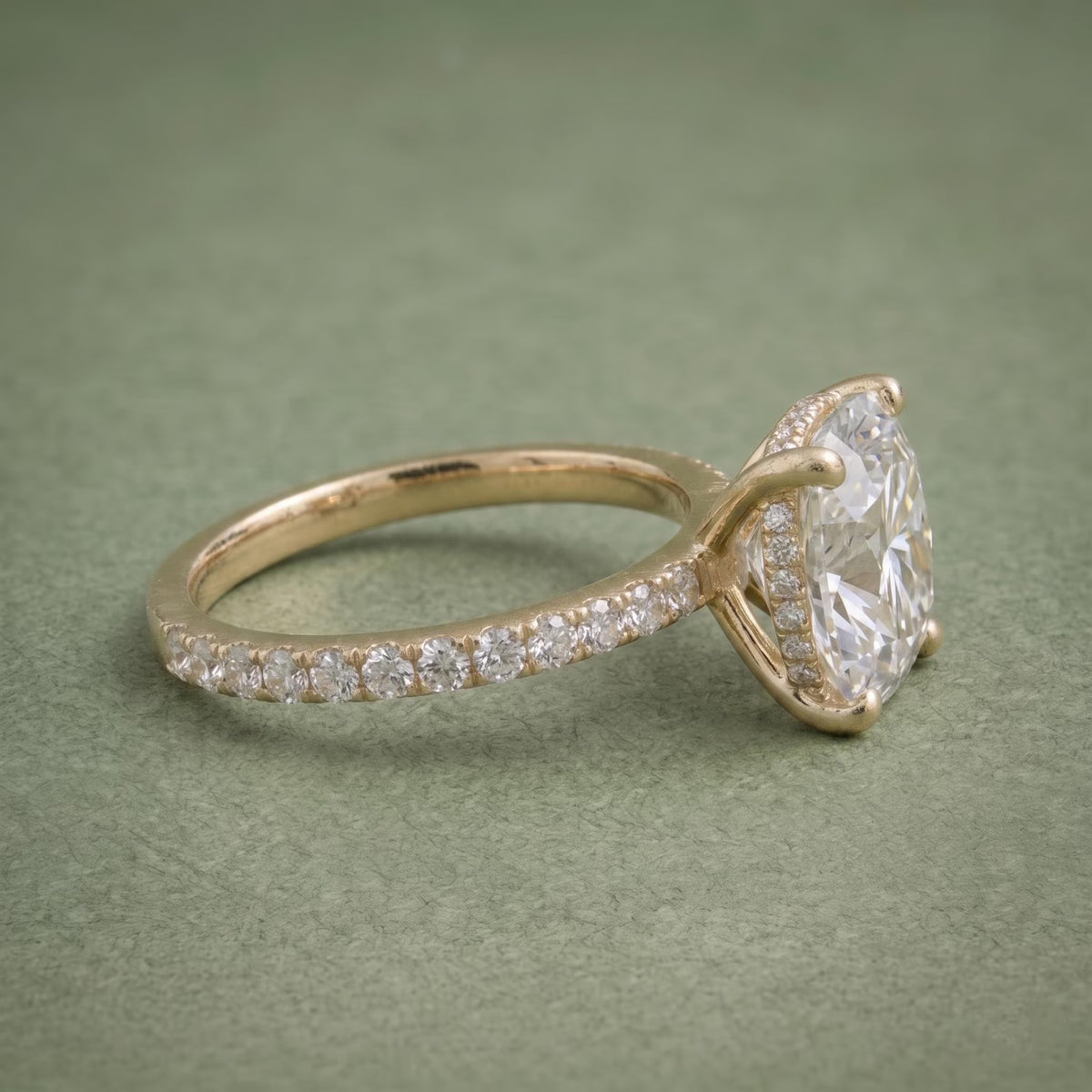 Alternate side angle of a 3 carat cushion lab grown diamond engagement ring with diamond accent band.
