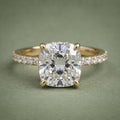 Direct front top-down view of a 3 CT cushion cut lab diamond set on a yellow gold pavé accent band.