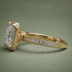 Side profile view of a 4 CT princess cut lab grown diamond halo engagement ring in 18K yellow gold with pavé band.