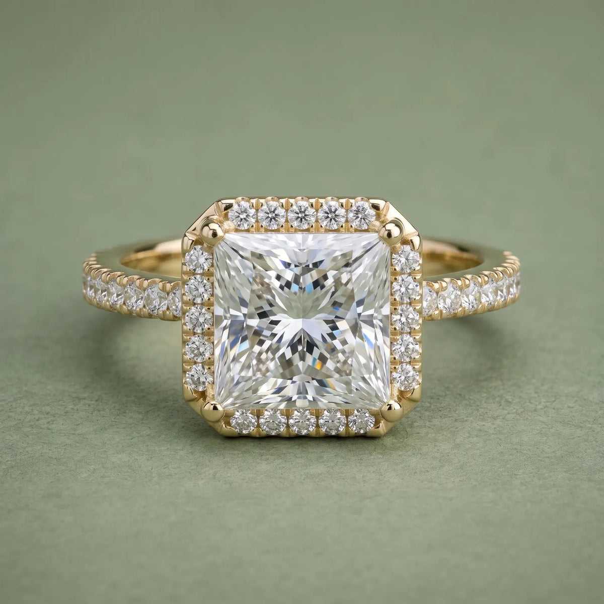 Direct top view showing a 4 carat princess cut lab diamond surrounded by a brilliant halo setting on a pavé band.