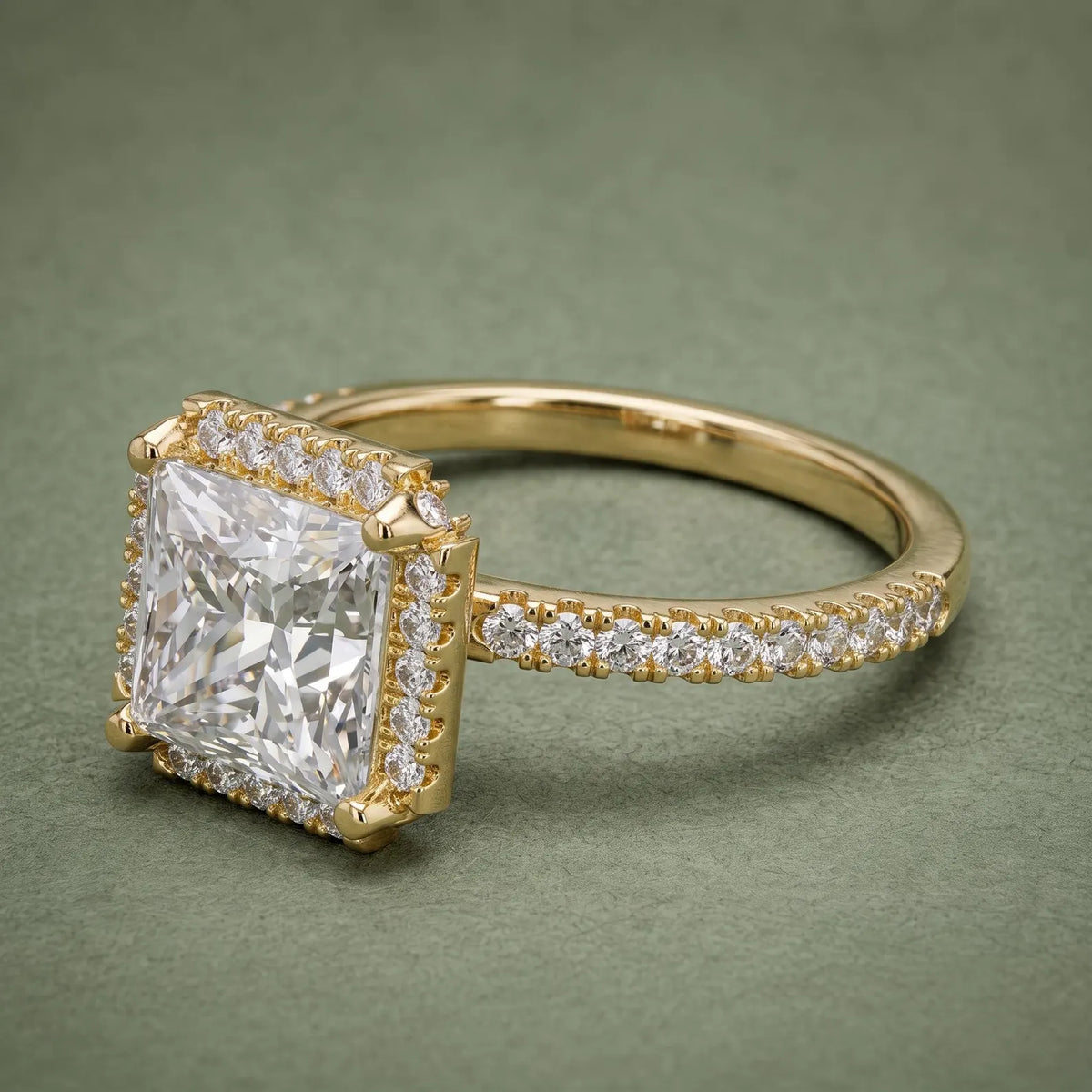 Three-quarter perspective of a 4 CT square princess cut lab diamond halo engagement ring in yellow gold.