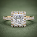 Top-down view of a 2 CT princess cut lab grown diamond halo ring with pavé shank in 14K yellow gold.