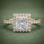 Top-down view of a 2 CT princess cut lab grown diamond halo ring with pavé shank in 14K yellow gold.